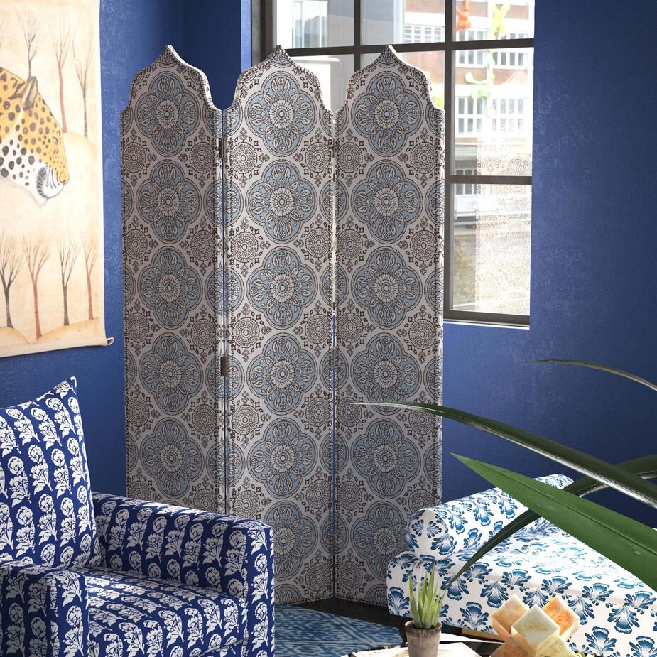 From left: the Kashida Swivel Chair in Mudetti Indigo, the Kinza Room Screen in Madura Vista, and the Tarifa Daybed in Bamana Lapis.

